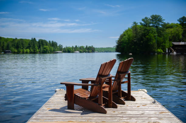 istock Adirondack chairs sitting on a wooden pier 1256422205