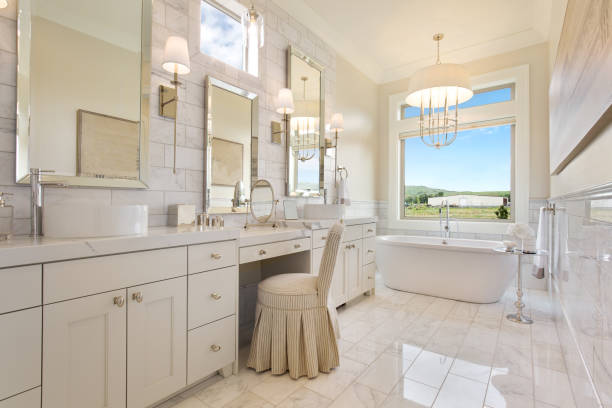 Gorgeous and large en suite bathroom with oversized window with amazing views Vanity chair and mirror and freestanding bathtub free standing bath photos stock pictures, royalty-free photos & images