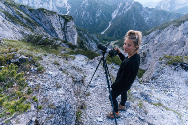 Young female photographer smiles at camera
