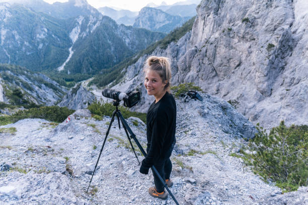 istock Young female photographer smiles at camera 1256428783