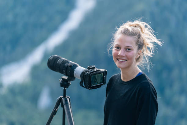 Young female photographer smiles at camera