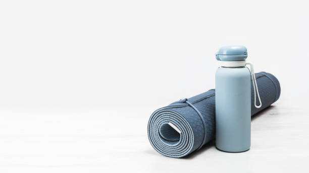 istock Rolled yoga mat and blue water bottle 1256431246