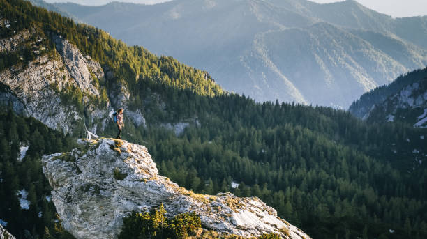 istock Hiker relaxes on mountain ridge at sunrise 1256432987