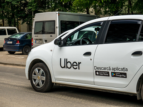 Bucharest/Romania - 06.22.2020: Uber logo inscriptioned on a white painted car. Uber car in traffic.