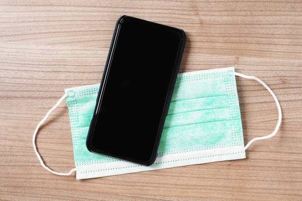 istock smartphone or mobile phone and face mask 1256434911