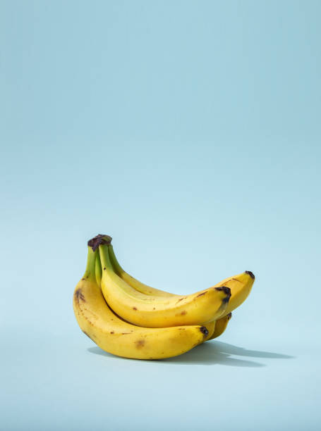 istock Bunch of bananas on a colored background. Bananas on a blue background with copy space 1256434943