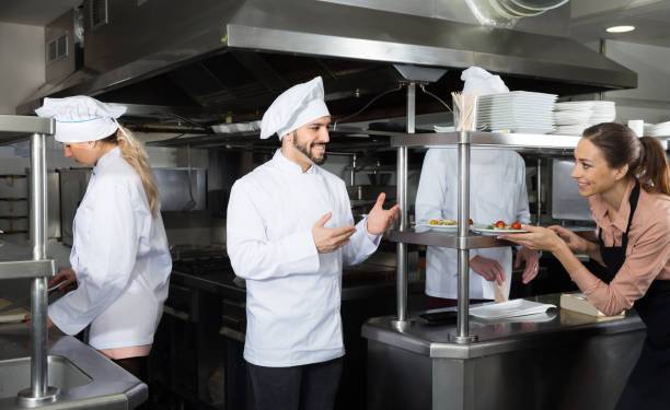istock Staff of restaurant with young chef in kitchen 1256438158