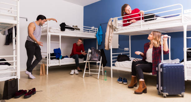 istock Travelers communicating in hostel bedroom 1256438434