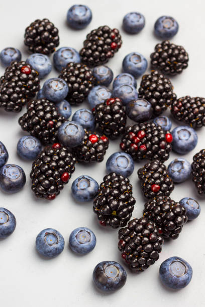 istock Blueberries, raspberries and blackberries on gray background 1256442630
