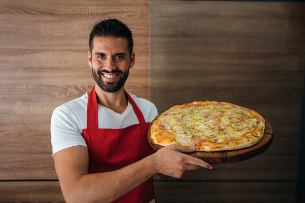 istock Portrait of smiling baker 1256445130