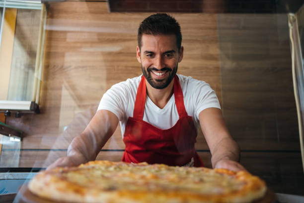 istock Portrait of smiling baker 1256445212