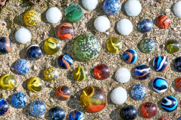 istock Marble balls in concrete as tile in garden 1256445456