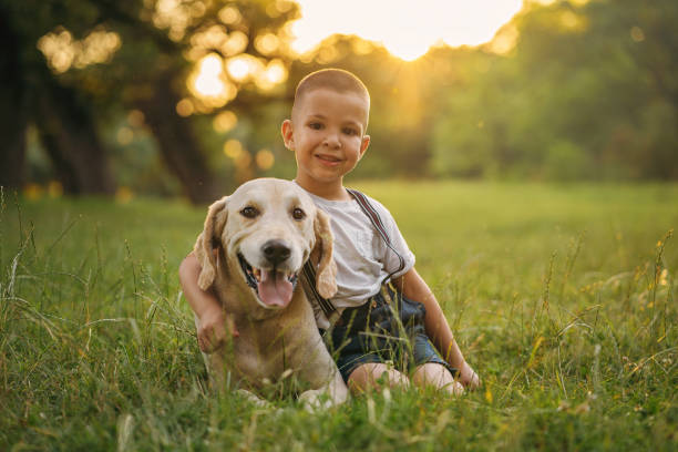 istock Cute boy cuddling with his Golden retriever 1256445560