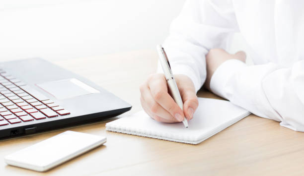 istock A girl sits at an office desk with a laptop. Working space 1256446535