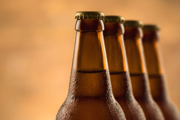 istock Brown full bottle of beer with water drops 1256446647