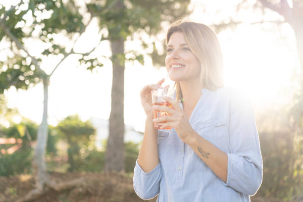 istock Beautiful girl drinking 1256454935