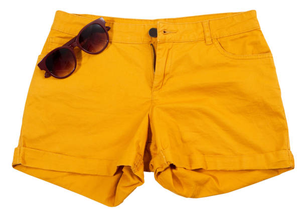 Orange shorts and sunglasses isolated on white background