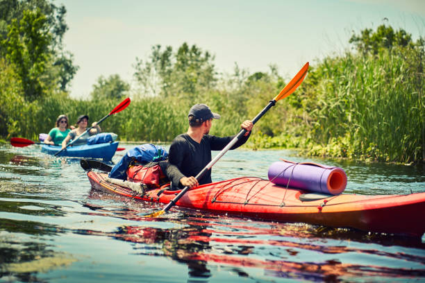 istock Happy best friends having fun on a kayaks. Kayaking on the river. 1256457308