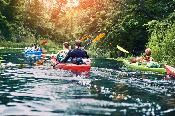 Happy best friends having fun on a kayaks. Kayaking on the river. group of young people on kayak outing rafting down the river canoeing stock pictures, royalty-free photos & images