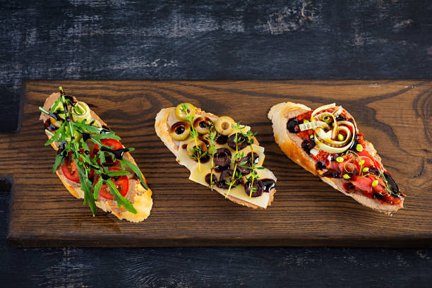 istock Bruschetta with chicken liver paste. Delicious bruschettas with various fillings. Different bruschetta ob wooden background 1256458994