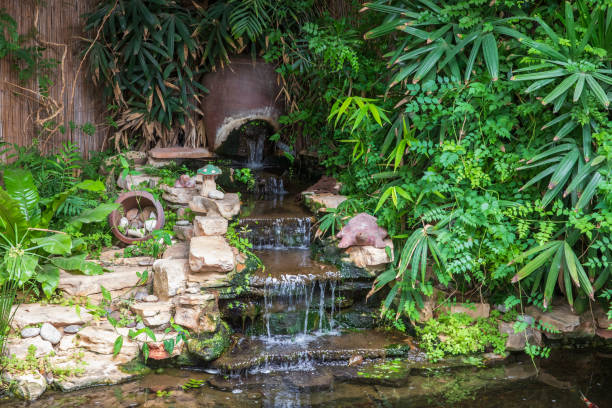 istock View on the decorative waterfall with various plants and decorations 1256459854