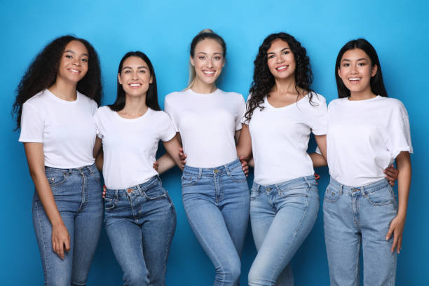 istock Diverse Girls Embracing Posing On Blue Background, Smiling To Camera 1256460423