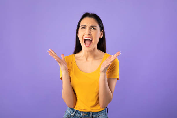 istock Young female grimacing, screaming and feeling furious 1256460978