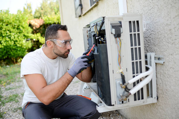 istock handsome young man electrician installing an air conditioning in a client house 1256462162