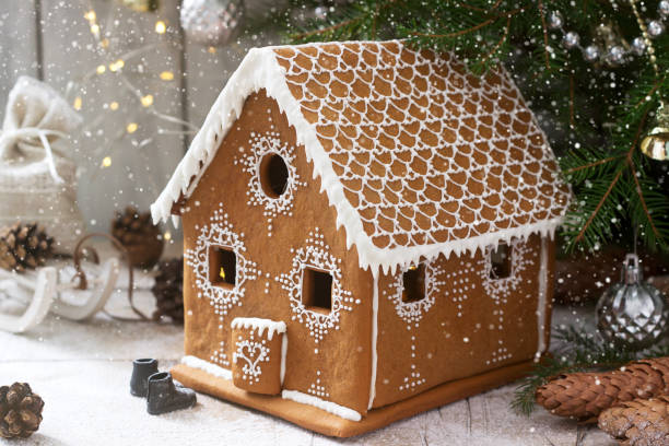 istock Gingerbread house and Christmas trees on a luminous background. Bokeh effect. 1256463201