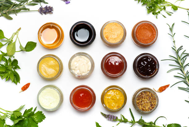 Large collection of sauces and spiced spreads in small jars isolated flat lay Large collection of sauces and spiced spreads in small jars isolated flat lay. Various herbs and dressings as mayo ketchup mustard soy sauce and many more food dressing stock pictures, royalty-free photos & images