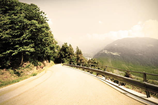 Winding asphalt road in the italian alps. Retro style