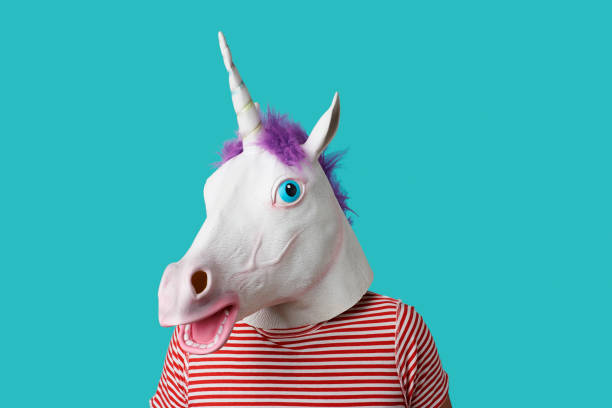 istock man wearing a unicorn mask 1256465874