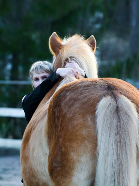 istock Woman hugging her horse 1256467553