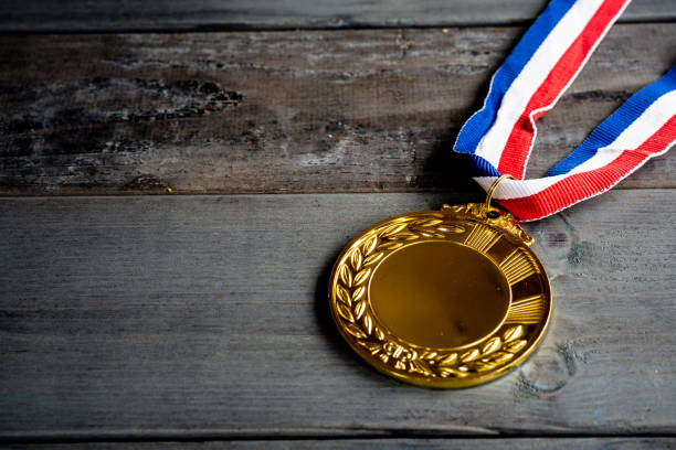 istock Gold medal on wood table background 1256469160