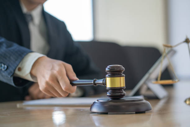 istock Judge hitting gavel at wooden table. 1256471969