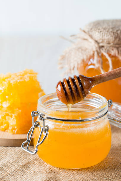 istock Honey in a jar on wooden rustic background 1256473879