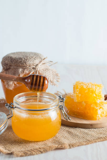 istock Honey in a jar on wooden rustic background 1256473887