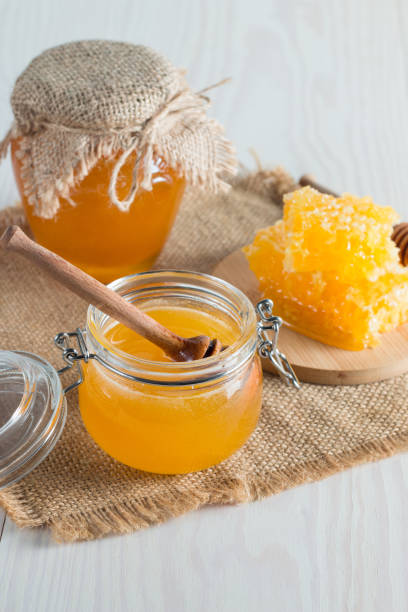 istock Honey in a jar on wooden rustic background 1256473895