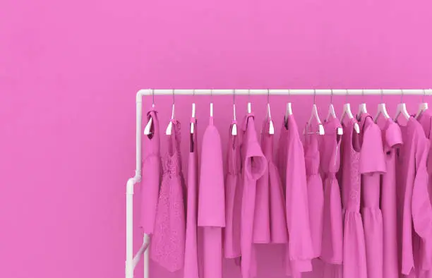 Photo of Hanger with pink women's clothing against the background of a pink wall. Monotonous pink clothes. Creative conceptual illustration with copy space. 3D rendering.