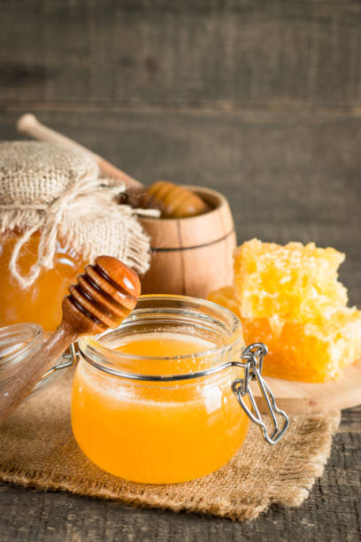 istock Honey in a jar on wooden rustic background 1256474044