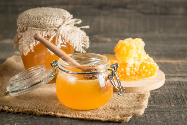 istock Honey in a jar on wooden rustic background 1256474052