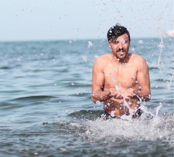 istock Young Men Enjoying on The Beach 1256474087