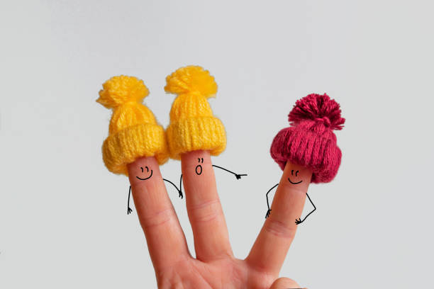 Funny fingers with a face in a winter hat.