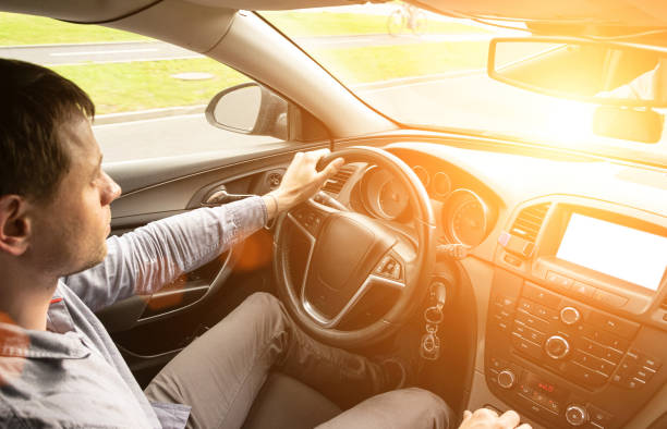 Road trip. Happy young man have fun travel inside car at sunset. Summer vacation concept with driver. Road trip. Happy young man have fun travel inside car at sunset. Summer vacation concept with driver undivided highway stock pictures, royalty-free photos & images