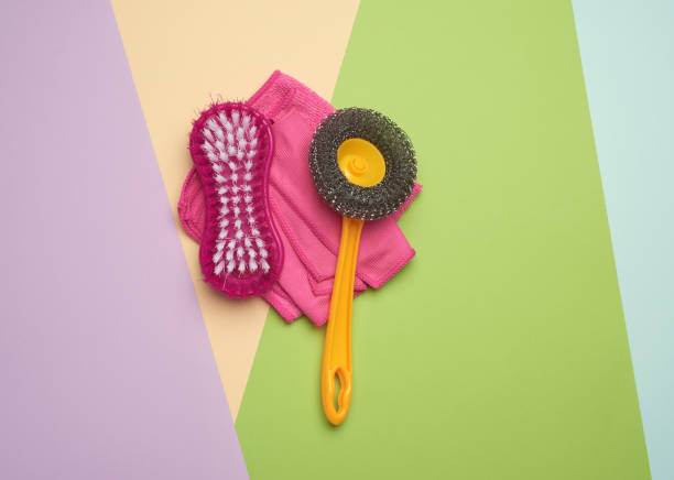istock pink plastic brushes and rag for cleaning the house on a color background 1256475358