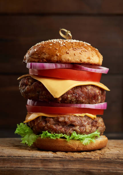 istock double cheeseburger with tomatoes, onions, barbecue cutlet and sesame bun 1256475405