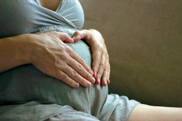 istock Heart shape on pregnant belly. 1256476742
