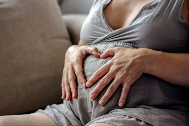 istock Heart shape on pregnant belly. 1256476820