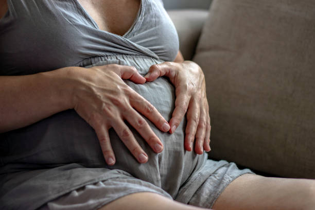 istock Heart shape on pregnant belly. 1256476973