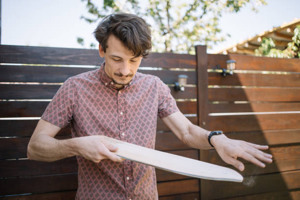 istock Brunette man cleaning wooden board from dust 1256476983